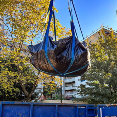 StrongSling ready to dump a load of construction debris into a container.